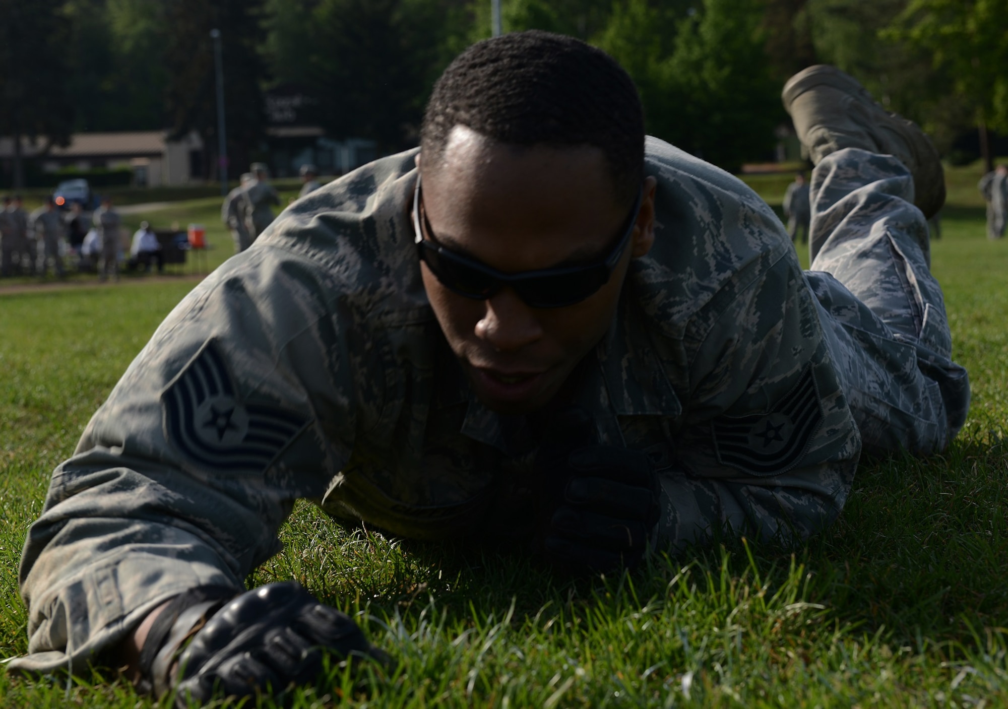 Tech. Sgt. Kevin Cuffie, 569th U.S. Forces Police Squadron flight chief, high crawls through the grass as part of the Battle of the Badges competition held in honor of National Police Week May 14, 2015, at Vogelweh Military Complex, Germany. The Airmen and Soldiers competing in the course performed a variety of moves ranging from squats to carrying 50-pound rucksacks. (U.S. Air Force photo/Airman 1st Class Tryphena Mayhugh)