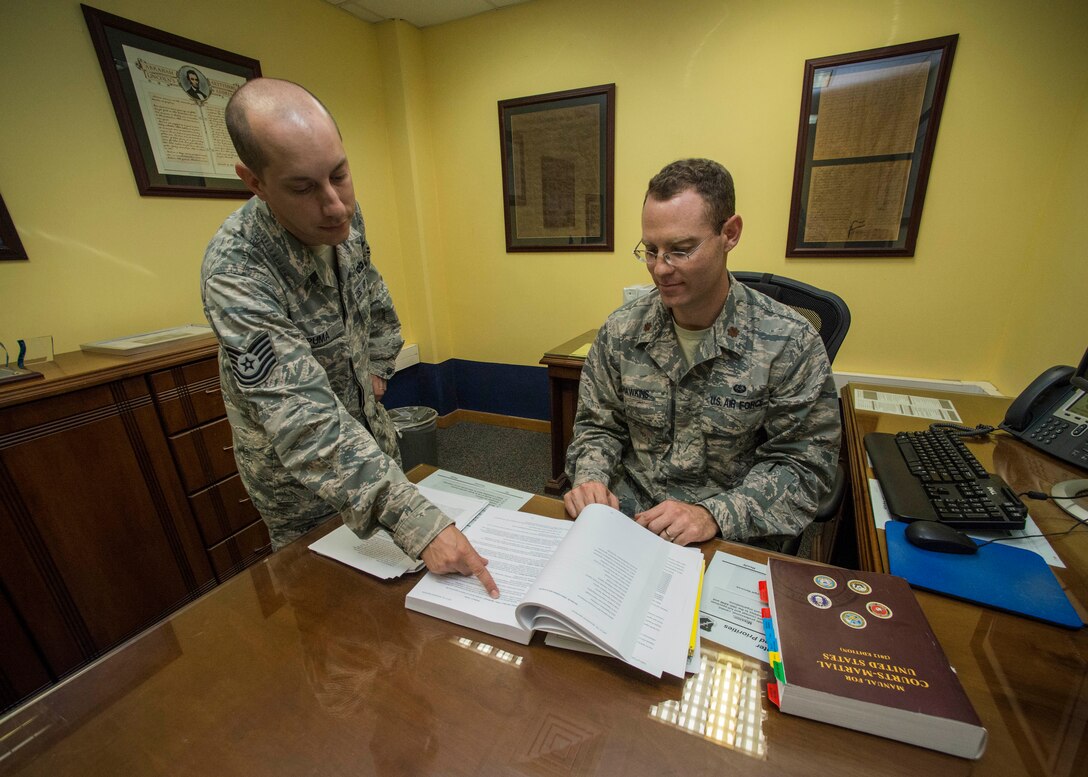 Tech. Sgt. Alexander Puma, 39th Air Base Wing NCO in charge of training and readiness, and Maj. Jeff Hawkins, 39th ABW deputy staff judge advocate, are two of three individuals recognized by U.S. Air Forces in Europe and Air Forces Africa for their contributions in the Office of the Staff Judge Advocate during the 2014 fiscal year May 2, 2015, at Incirlik Air Base, Turkey. Hawkins was presented the Albert M. Kuhfeld Award Outstanding Young Judge Advocate of the Year Award, Puma was presented the Steve Swigonski Award Outstanding Young Paralegal of the Year Award and Master Sgt. Dean Lares, 39th ABW law office superintendent, was presented the Karen Yates-Popwell Award Outstanding Paralegal Senior NCO of the Year Award. (U.S. Air Force photo by Airman 1st Class Cory W. Bush/Released)