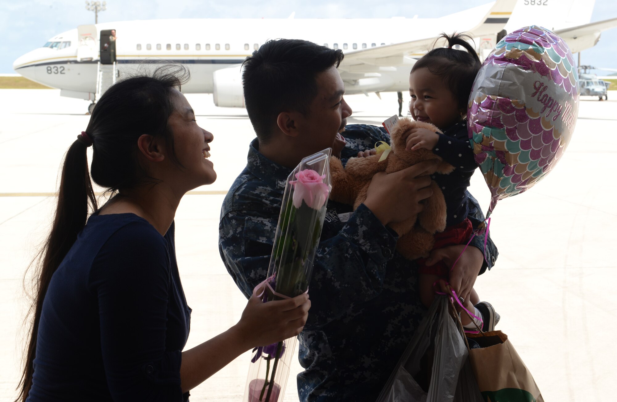Aviation Electronics Technician Petty Officer 2nd Class Nico-Vincent Diaz, Helicopter Sea Combat Squadron 25, greets his family after a five month deployment May 11, 2015, at Andersen Air Force Base, Guam. HSC-25 worked closely with the 31st Marine Expeditionary Unit while fostering interoperability between the Navy and Marine Corps. (U.S. Air Force photo by Senior Airman Amanda Morris/Released)