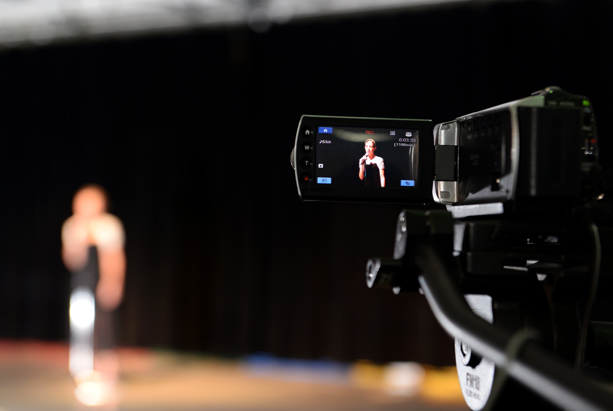 A camera records an audition for Operation Talent Search May 7, 2015, at Andersen Air Force Base, Guam. The overall winner for Andersen will receive a trophy and get the opportunity to compete at the Air Force level. (U.S. Air Force photo by Senior Airman Amanda Morris/Released)