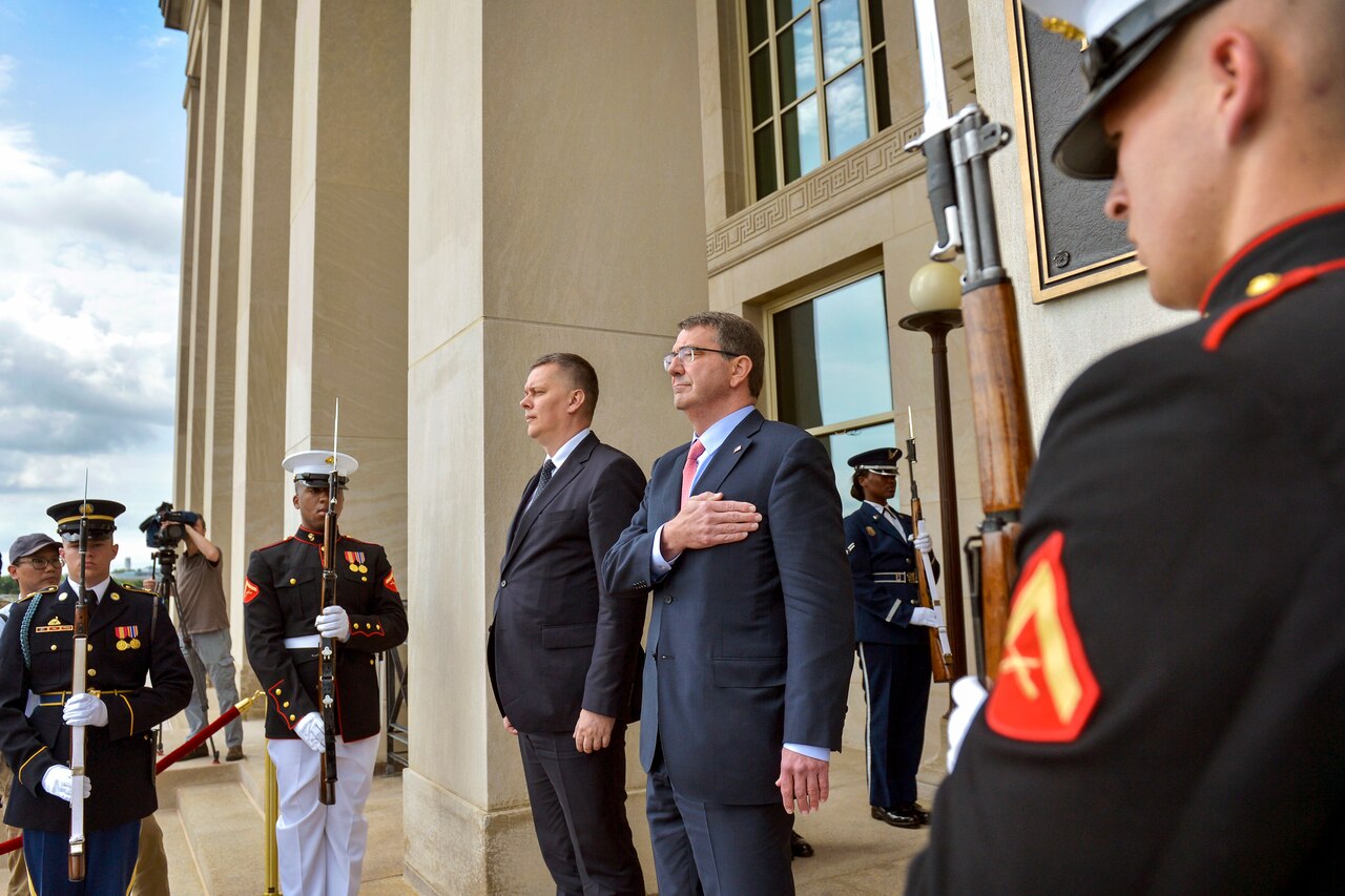 U.S. Defense Secretary Ash Carter, right, and Polish Defense Minister Tomasz Siemoniak pause as a military band plays the U.S. and Polish national anthems during an honor cordon at the Pentagon, May 19, 2015. Carter hosted the event to welcome the defense minister before they met to discuss matters of mutual importance. DoD photo by Glenn Fawcett