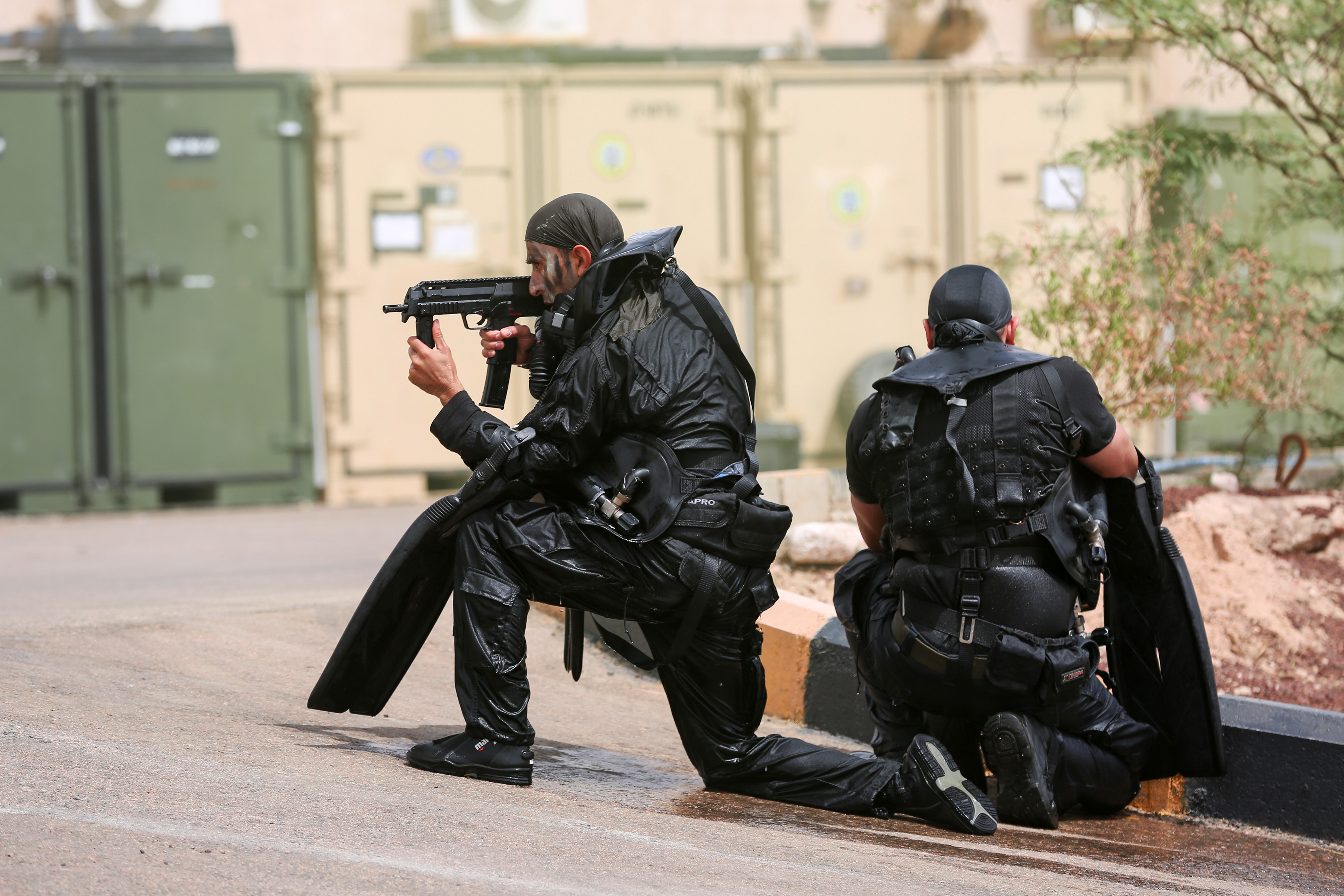 Jordanian commandos take up positions after emerging from the
