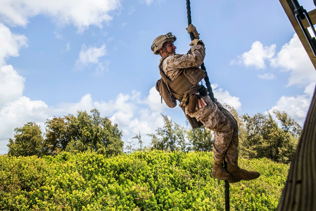 Marine Lance Cpl. Jose Cortez fast-ropes from a tower on marine Corps Base Hawaii, May 12, 2015. Cortez is assigned to Battalion Landing Team, 3rd Battalion, 1st Marine Regiment, 15th Marine Expeditionary Unit’s Maritime Raid Force security element.