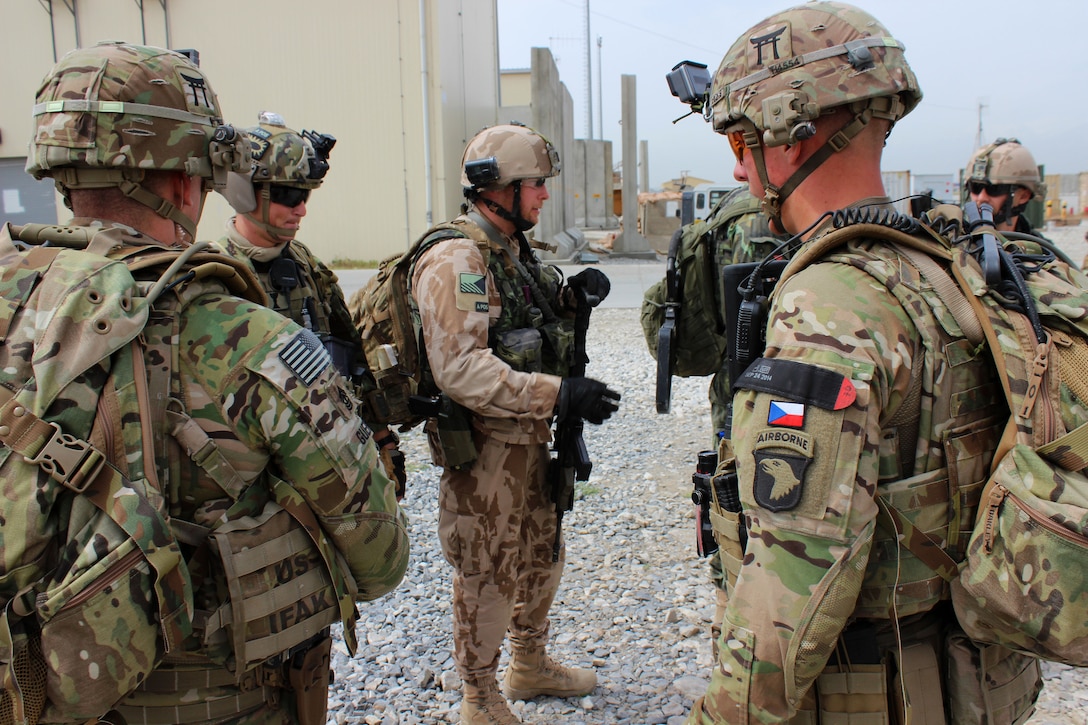 U.S., Czech, and Georgian soldiers receive a mission brief before ...