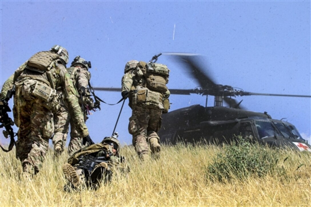 U.S. soldiers evacuate a simulated casualty during a combined arms live-fire training exercise in Laghman province, Afghanistan, May 13, 2015.  The soldiers are assigned to the 101st Airborne Division's 3rd Brigade Comabt Team. Train, Advise, Assist Command East conducted the exercise to demonstrate opportunities for the Afghan soldiers to plan, manage and conduct combined arms training on their ranges.