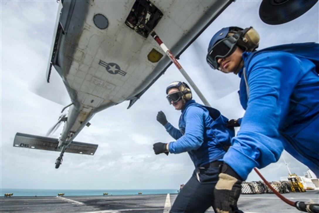 U.S. Navy Seamen Douglas McLain, left, and Cynthia Cea secure a hoist sling to an MH-60S Seahawk helicopter on the flight deck of the Military Sealift Command hospital ship USNS Comfort during flight operations to support Continuing Promise 2015 in the Caribbean Sea, May 17, 2015. The operation conducts humanitarian-civil assistance, subject matter expert exchanges, and medical, dental, veterinary and engineering support to partner nations.