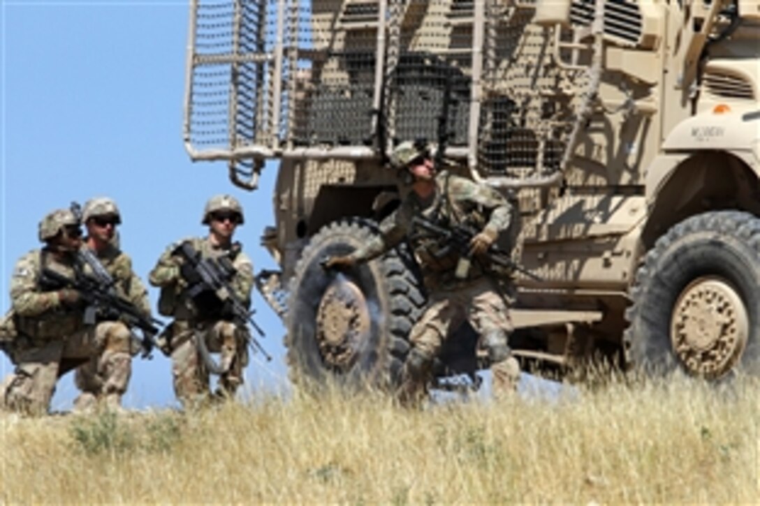 A U.S. soldier prepares to toss a smoke grenade during a combined arms live-fire training exercise in Laghman province, Afghanistan, May 13, 2015. The soldiers are assigned to the 101st Airborne Division's 3rd Brigade Comabt Team. Train, Advise, Assist Command East conducted the exercise in two locations to demonstrate opportunities for the Afghan soldiers to plan, manage and conduct combined arms training on their ranges.