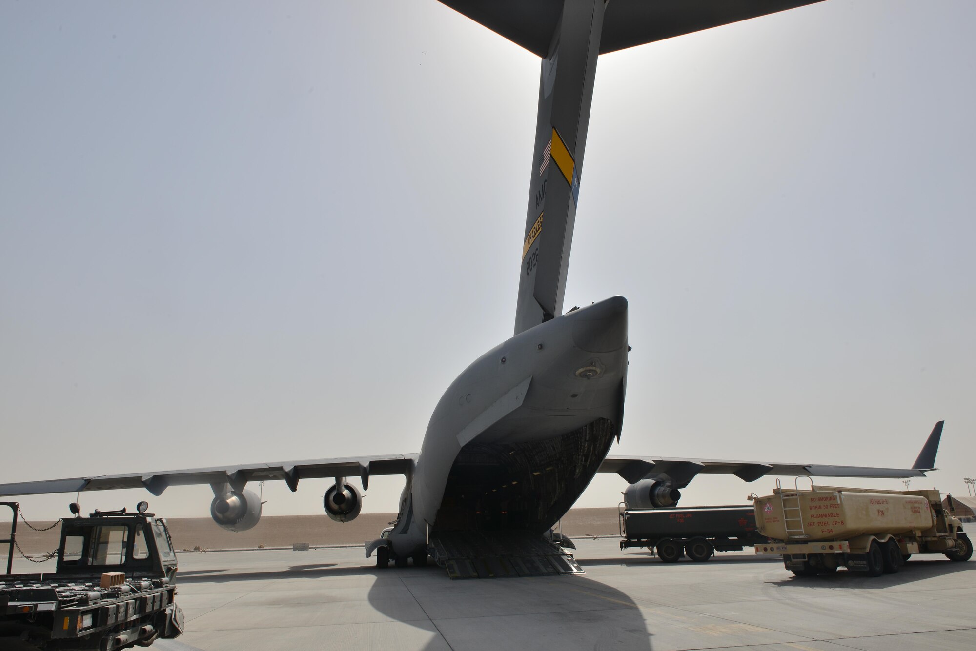 A C-17 Globemaster aircraft assigned to the 437th Air Lift Wing, Joint base Charleston, South Carolina, is being fueled and prepared to be load with equipment to support RED HORSE Civil Engineering operations to repair a runway in Southwest Asia May 13, 2015 at Al Udeid Air Base, Qatar. (U.S. Air Force photo/Staff Sgt. Alexandre Montes)