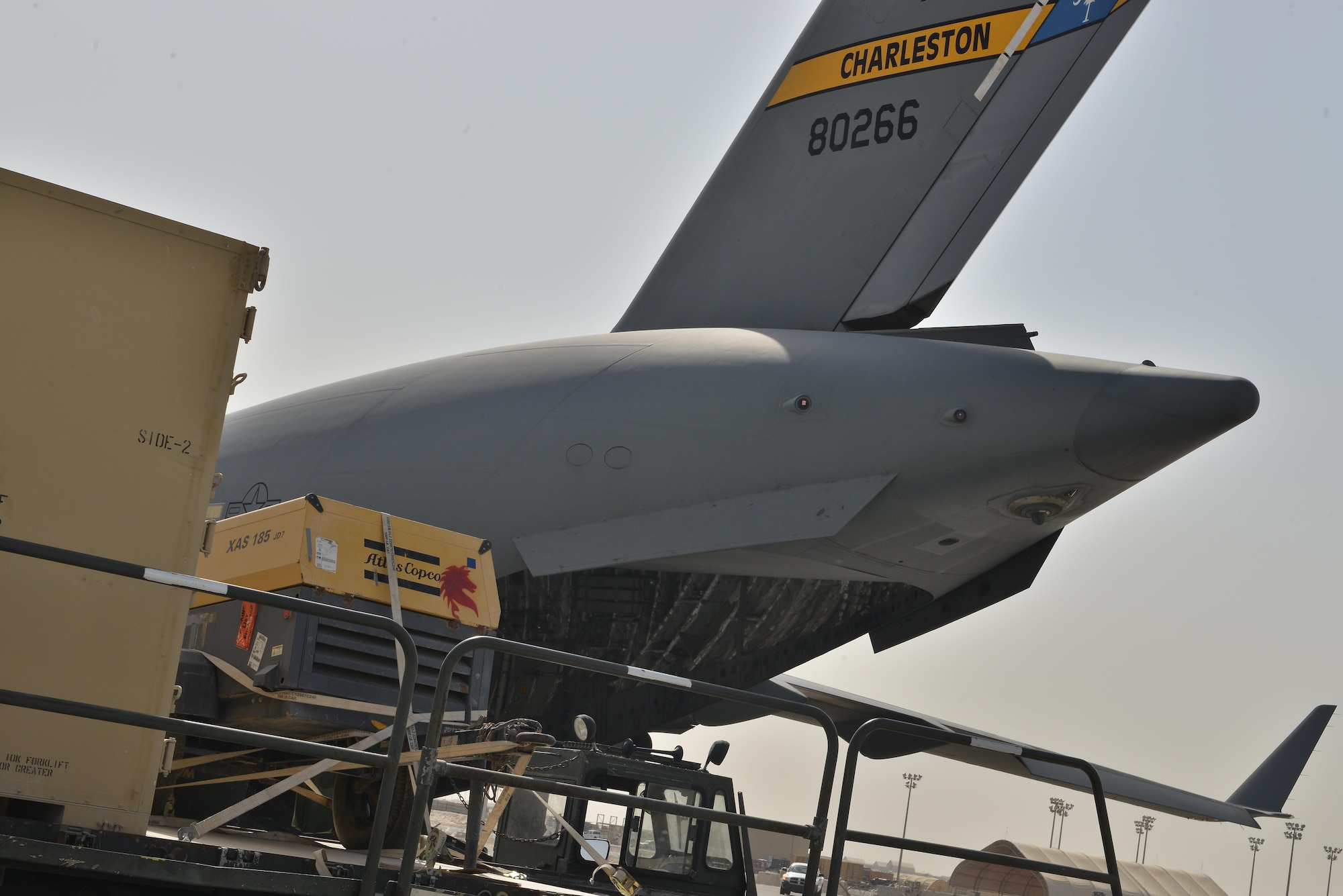 A C-17 Globemaster aircraft assigned to the 437th Air Lift Wing, Joint base Charleston, South Carolina, is prepared to be loaded with equipment to support RED HORSE Civil Engineering operations to repair a runway in Southwest Asia May 13, 2015 at Al Udeid Air Base, Qatar. (U.S. Air Force photo/Staff Sgt. Alexandre Montes) 