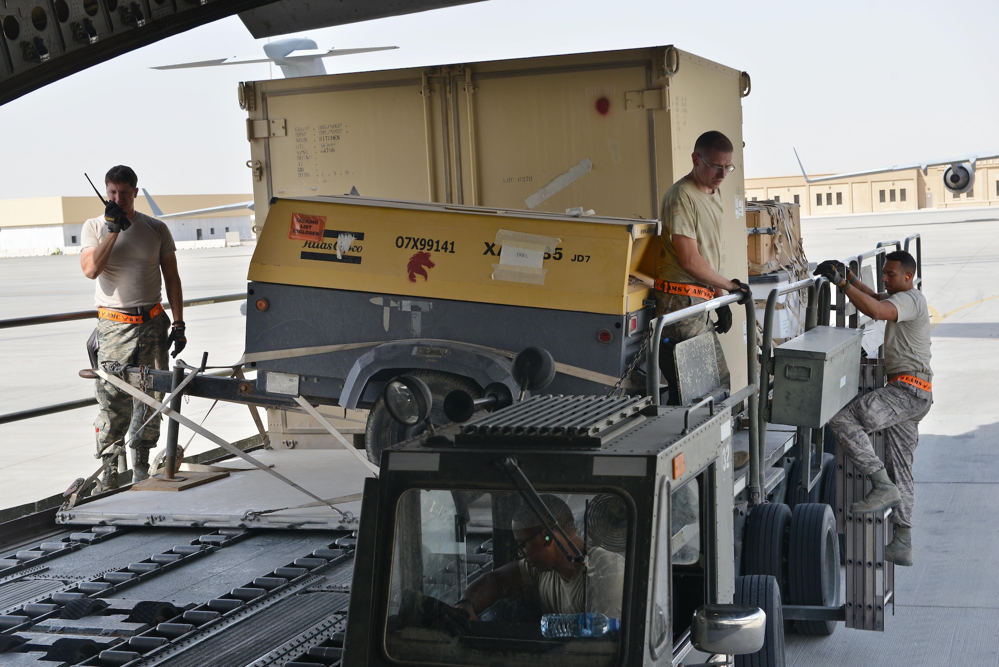 Airmen from the 8th Expeditionary Air Mobility Squadron load generators onto a C-17 Globemaster aircraft prior to take off May 13, 2015 at Al Udeid Air Base, Qatar. Airmen from separate squadrons deployed to Al Udeid helped support a mission for forward deployed members of RED HORSE Civil Engineering to repair a runway in Southwest Asia in support of Operation Inherent Resolve. (U.S. Air Force photo/Staff Sgt. Alexandre Montes)