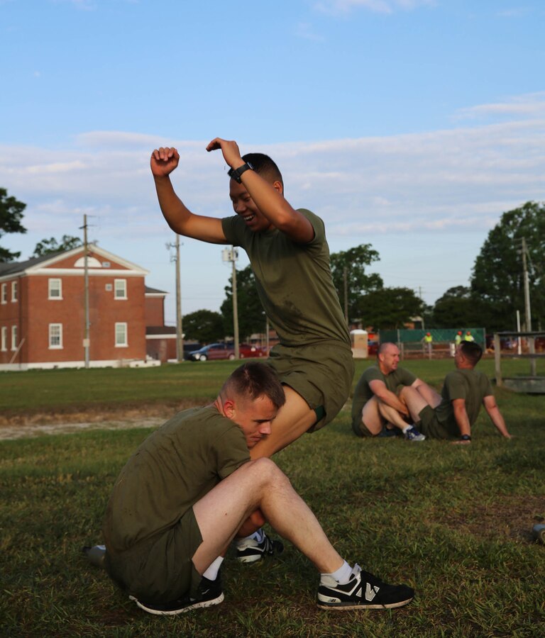 U.S. Marine Corps Pfc. Chengmor Vang, right, 22nd Marine Expeditionary Unit (MEU) administration clerk and native of Minneapolis, performs a standing sit-up with the help of Lance Cpl. Cody Obrien, left, 22nd MEU marine-air-ground-task-force planner and native of Tampa Bay, Fla., as part of an operational pause (OP) at Marine Corps Base Camp Lejeune, N.C., May 19, 2015. The MEU participated in the OP to increase a safety-minded culture focusing on risk management, on and off duty safe behavior, and combat readiness. (U.S. Marine Corps photo by Cpl. Caleb McDonald/Released)