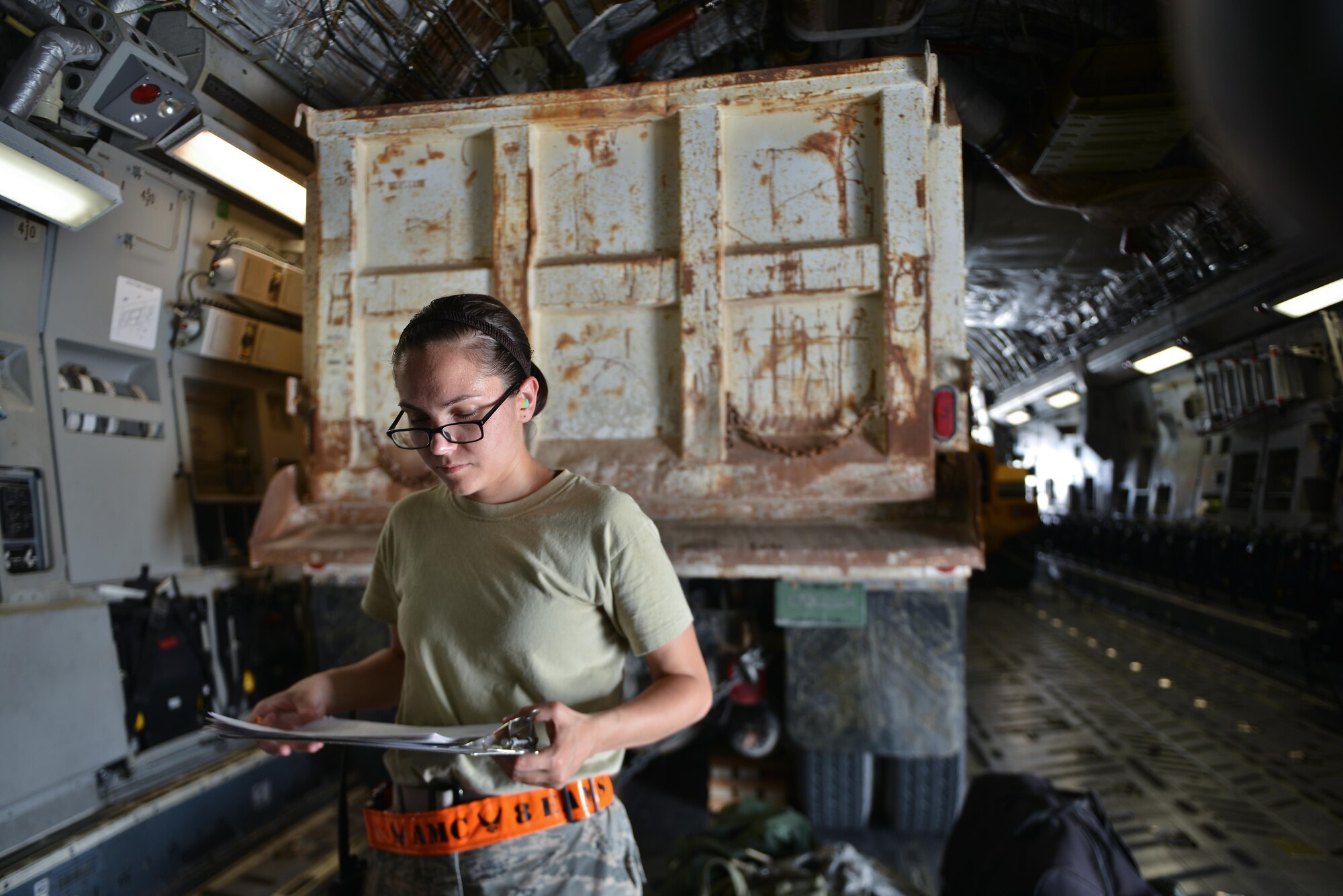 Airman 1st Class Kimberly Wolfgang, 8th Expeditionary Air Mobility Squadron, reviews a equipment manifest to configure weight distribution on a C-17 Globemaster aircraft May 13, 2015 at Al Udeid Air Base, Qatar. Airmen from separate squadrons deployed to Al Udeid helped support a mission for forward deployed members of RED HORSE Civil Engineering to repair a runway in Southwest Asia in support of Operation Inherent Resolve. (U.S. Air Force photo/Staff Sgt. Alexandre Montes)