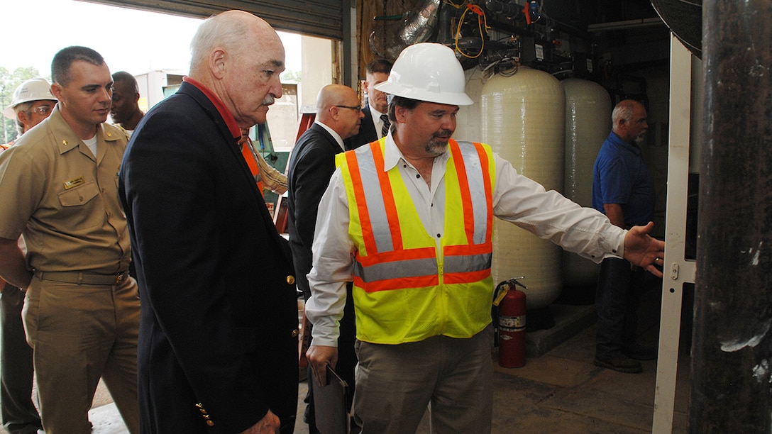 Assistant Secretary of the Navy, the Honorable Dennis V. McGinn (center), Energy, Installations and Environment, tours the ground source heat pump project area with Charles W. Hammock Jr., vice president, Andrews, Hammock and Powell, INC., during his visit to Marine Corps Logistics Base Albany, Georgia, May 19. The project is a borehole thermal energy storage system which is a state-of-the-art ground source heat pump system for heating and cooling Building 3700, the Marine Corps Logistics Command headquarters building.  
