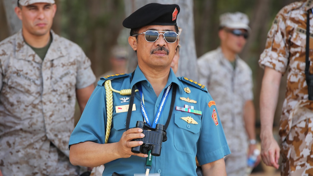 Indonesian Navy Col. Halili, naval attache to the United States, watches an amphibious landing conducted by the 15th Marine Expeditionary Unit during the MARFORPAC-hosted U.S. Pacific Command Amphibious Leaders Symposium at Marine Corps Training Area Bellows May 19, 2015. PALS is designed to bring together senior leaders of allied and partner Marine Corps, naval infantries, and militaries spanning the Indo-Asia-Pacific region with interest in military amphibious capability development. This year, 22 nations sent representatives to observe the training.