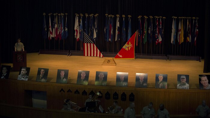 The photographs of 11 fallen service members line a theater stage, commemorating the individuals during their celebration of life ceremony, May 15, 2015, aboard Marine Corps Base Camp Lejeune, North Carolina. The seven MARSOC Marines and four Louisiana Army National Guardsmen pictured were killed when a UH-60 Black Hawk Helicopter crashed during amphibious operations involving helicopter and boat insertion and extraction training near Eglin, Fla., March 10. (U.S. Marine Corps photo by Cpl. Steven Fox/Released)