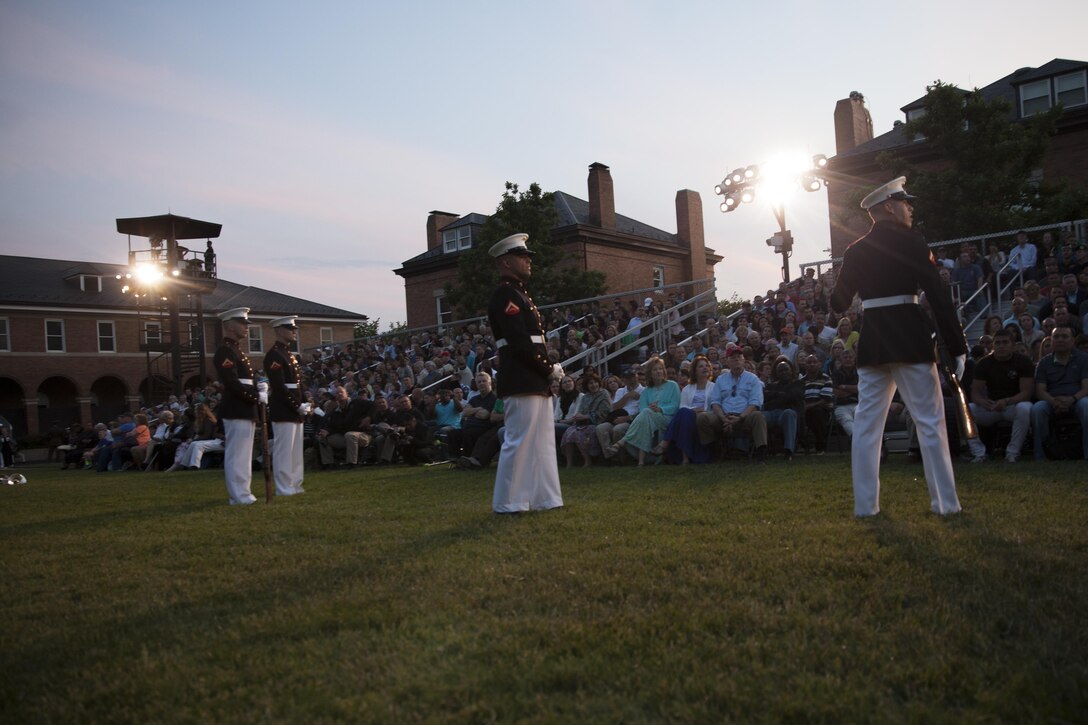 Marines with Marine Barracks Washington, D.C., educate the crowd before an evening parade, May 15, 2015. The Evening Parade summer tradition began in 1934 and features the Silent Drill Platoon, the U.S. Marine Band, the U.S. Marine Drum and Bugle Corps and two marching companies. More than 3,500 guests attend the parade every week. (U.S. Marine Corps photo by Lance Cpl. Alejandro Sierras/ Released)