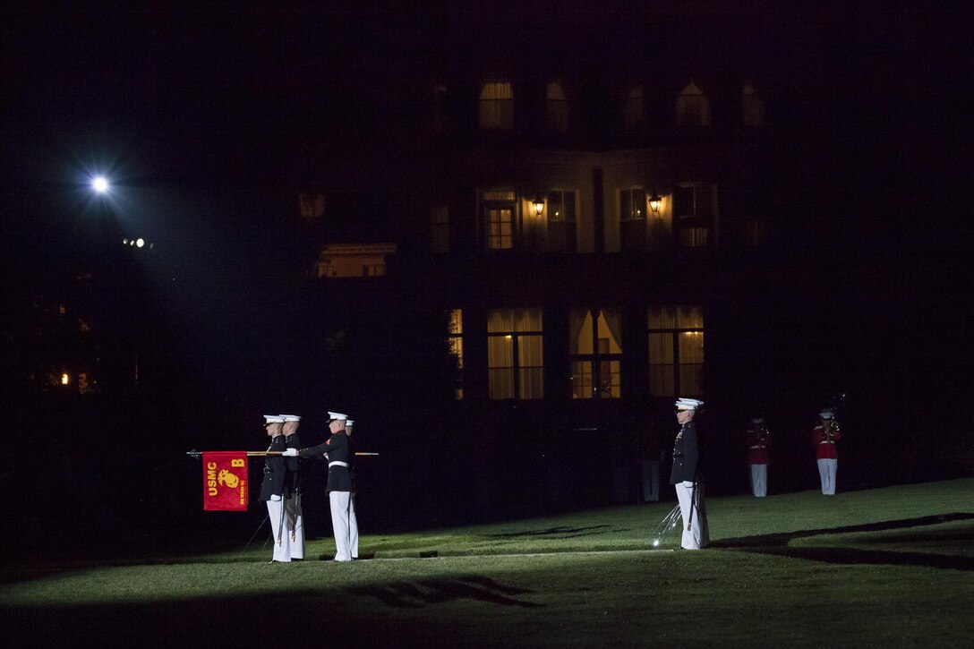 Marines with Marine Barracks Washington, D.C., perform during an evening parade, May 15, 2015. The Evening Parade summer tradition began in 1934 and features the Silent Drill Platoon, the U.S. Marine Band, the U.S. Marine Drum and Bugle Corps and two marching companies. More than 3,500 guests attend the parade every week. (U.S. Marine Corps photo by Lance Cpl. Alejandro Sierras/ Released)
