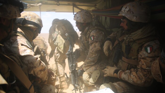Italian Marines exit a U.S. Amphibious Assault Vehicle from Kilo Company, Battalion Landing Team 3rd Battalion, 6th Marine Regiment, 24th Marine Expeditionary Unit, during bilateral platoon attack drills as part of Exercise Eager Lion 2015 in Jordan, May 11, 2015. Eager Lion is a recurring multinational exercise designed to strengthen military-to-military relationships, between partner nations and enhance regional security and stability. The 24th MEU is embarked on the ships of the Iwo Jima Amphibious Ready Group and deployed to maintain regional security in the U.S. 5th Fleet area of operations. 