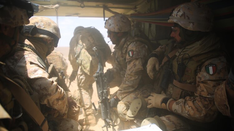 Italian Marines exit a U.S. Amphibious Assault Vehicle from Kilo Company, Battalion Landing Team 3rd Battalion, 6th Marine Regiment, 24th Marine Expeditionary Unit, during bilateral platoon attack drills as part of Exercise Eager Lion 2015 in Jordan, May 11, 2015. Eager Lion is a recurring multinational exercise designed to strengthen military-to-military relationships, between partner nations and enhance regional security and stability. The 24th MEU is embarked on the ships of the Iwo Jima Amphibious Ready Group and deployed to maintain regional security in the U.S. 5th Fleet area of operations. 