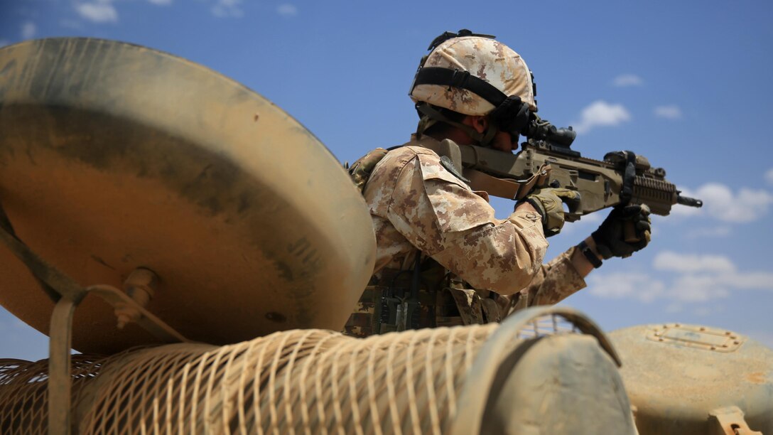 150511-M-WA276-143: JORDAN (May 11, 2015) An Italian Marine provides security from an Amphibious Assault Vehicle from Kilo Company, Battalion Landing Team 3rd Battalion, 6th Marine Regiment, 24th Marine Expeditionary Unit, during bilateral platoon attack drills as part of Exercise Eager Lion 2015 in Jordan, May 11, 2015. Eager Lion is a recurring multinational exercise designed to strengthen military-to-military relationships, between partner nations and enhance regional security and stability. The 24th MEU is embarked on the ships of the Iwo Jima Amphibious Ready Group and deployed to maintain regional security in the U.S. 5th Fleet area of operations. 