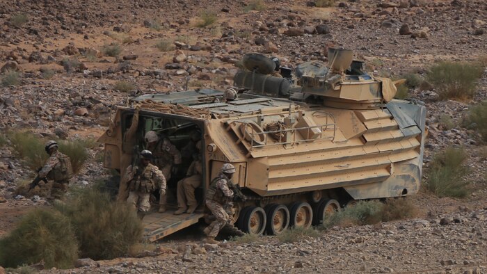 Italian Marines exit an Amphibious Assault Vehicle from Kilo Company, Battalion Landing Team 3rd Battalion, 6th Marine Regiment, 24th Marine Expeditionary Unit, during bilateral platoon attack drills as part of Exercise Eager Lion 2015 in Jordan, May 11, 2015. Eager Lion is a recurring multinational exercise designed to strengthen military-to-military relationships, between partner nations and enhance regional security and stability. The 24th MEU is embarked on the ships of the Iwo Jima Amphibious Ready Group and deployed to maintain regional security in the U.S. 5th Fleet area of operations.