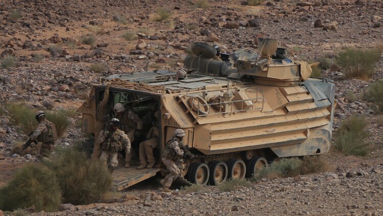 Italian Marines exit an Amphibious Assault Vehicle from Kilo Company, Battalion Landing Team 3rd Battalion, 6th Marine Regiment, 24th Marine Expeditionary Unit, during bilateral platoon attack drills as part of Exercise Eager Lion 2015 in Jordan, May 11, 2015. Eager Lion is a recurring multinational exercise designed to strengthen military-to-military relationships, between partner nations and enhance regional security and stability. The 24th MEU is embarked on the ships of the Iwo Jima Amphibious Ready Group and deployed to maintain regional security in the U.S. 5th Fleet area of operations.