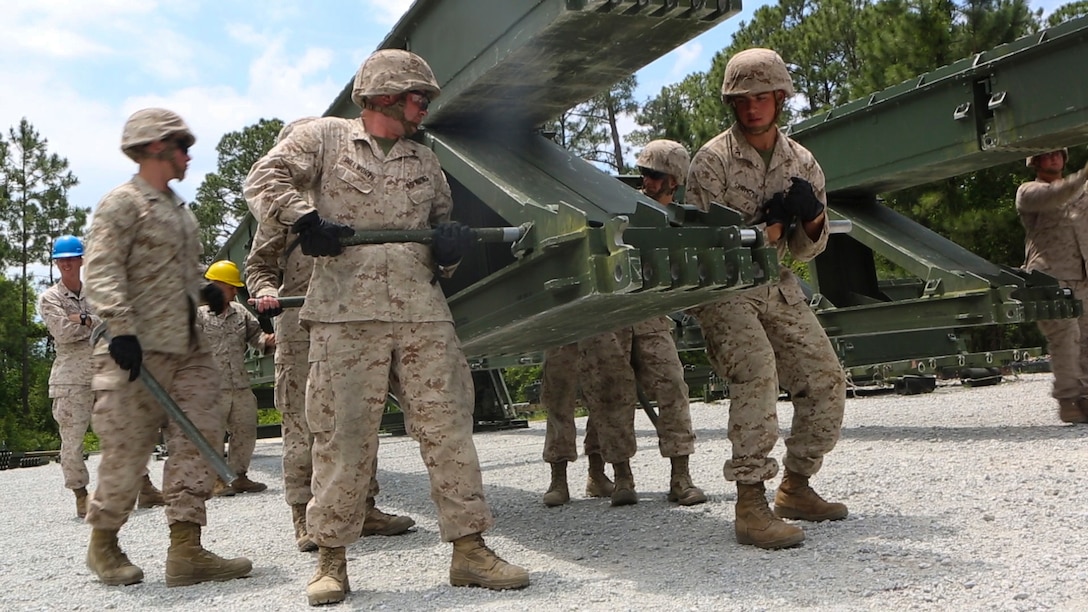 Marines with Bridge Company, 8th Engineering Support Battalion, disassemble a 16-bay, double-story bridge during a bridge masters course at Marine Corps Base Camp Lejeune, North Carolina, May 15, 2015.  The unit employs bridges capable of holding M1A1 Abrams tanks, and provides a key element in supporting operations in different terrain.