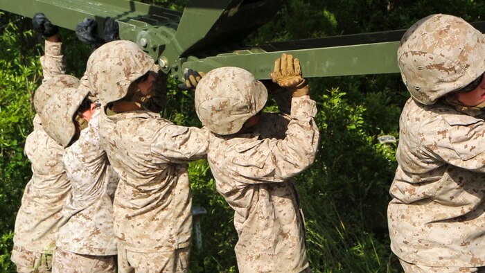Marines with Bridge Company, 8th Engineering Support Battalion, disassemble a 16-bay, double-story bridge during a bridge masters course at Marine Corps Base Camp Lejeune, North Carolina, May 15, 2015.  The unit employs bridges capable of holding M1A1 Abrams tanks, and provides a key element in supporting operations in different terrain.