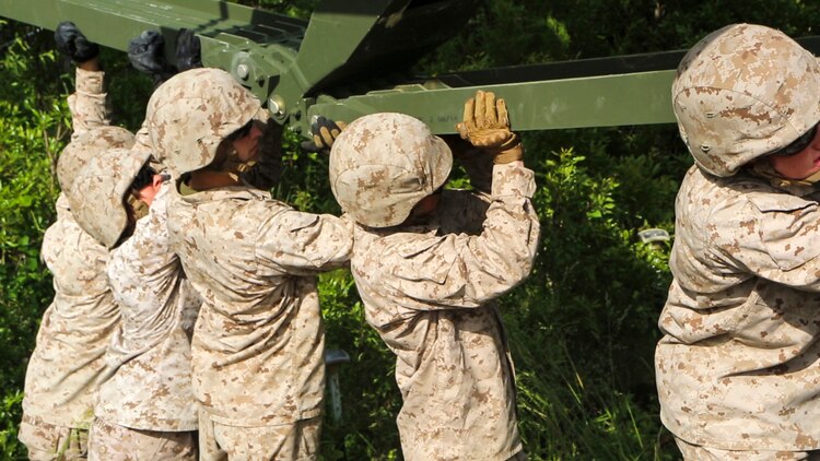 Marines with Bridge Company, 8th Engineering Support Battalion, disassemble a 16-bay, double-story bridge during a bridge masters course at Marine Corps Base Camp Lejeune, North Carolina, May 15, 2015.  The unit employs bridges capable of holding M1A1 Abrams tanks, and provides a key element in supporting operations in different terrain.