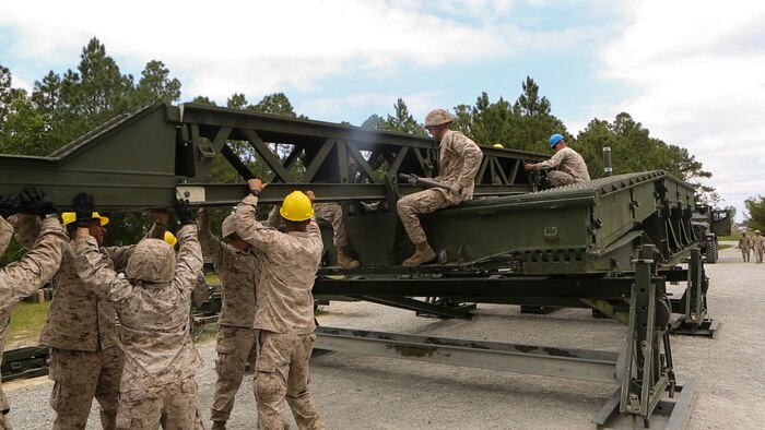 Marines with Bridge Company, 8th Engineering Support Battalion, disassemble a 16-bay, double-story bridge during a bridge masters course at Marine Corps Base Camp Lejeune, North Carolina, May 15, 2015.  The unit employs bridges capable of holding M1A1 Abrams tanks, and provides a key element in supporting operations in different terrain.