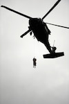 A Texas Army National Guard UH-60 Black Hawk crew, partnered with Texas Task Force 1, rescues a victim during a training exercise, April 24, 2015, at Lake Bryan in Bryan, Texas. The Texas Army National Guard trains side by side with Texas Task Force 1 in order to be ready to help Texans in need during natural and man-made disasters.