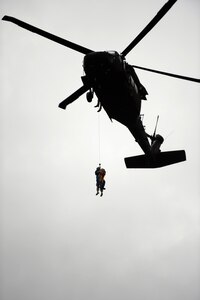 A Texas Army National Guard UH-60 Black Hawk crew, partnered with Texas Task Force 1, rescues a victim during a training exercise, April 24, 2015, at Lake Bryan in Bryan, Texas. The Texas Army National Guard trains side by side with Texas Task Force 1 in order to be ready to help Texans in need during natural and man-made disasters.