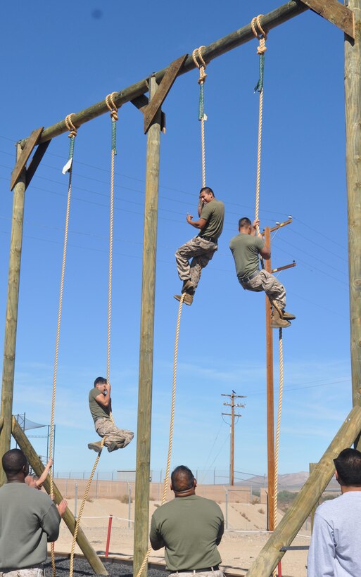 Sgt. Moses Machuca, a substance abuse control officer aboard Marine
Corps Logistics Base Barstow, Calif., yells "CrossFit" at the top of the rope
obstacle during a competition on the obstacle course on MCLB Barstow,
Oct. 10. The O-Course allows Marines to maintain combat readiness and
fitness standards.
