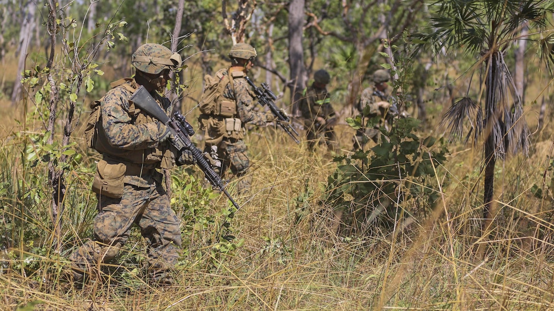 Marines with Company A, 1st Battalion, 4th Marine Regiment, Marine Rotational Force – Darwin, patrol through vegetation during a mock squad attack as part of a live-fire training event May 14 to 16 at Kangaroo Flats Training Area, Victoria, Northern Territory, Australia. The Marines and Australian soldiers with 5th Battalion Royal Australian Regiment, Australian Army, Australian Defence Force, brushed up on squad attack tactics, basic point man skills and explosives to refine basic infantry skills. Company A is a part of the Marine Air Ground Task Force that is composed of an air, ground, logistics and command element creating the MRF-D. The rotational deployment in Darwin enables Marines to more effectively train, exercise and operate with their partners, enhancing regional security and building a capacity to respond more rapidly to natural disasters and crises throughout that region.