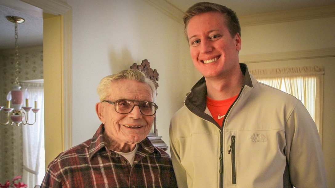 Clemson University junior Will Hines chats with retired U.S. Marine Staff Sgt. Robert A. Henderson, 95, a Pearl Harbor survivor, Feb. 210, 2015. Hines was interviewing Henderson for an undergraduate research project at Clemson in which he tapes interviews with veterans and sends copies to the Library of Congress to be preserved forever. Henderson spoke about watching from a hillside as Japanese planes started dropping torpedoes on U.S. targets. "The first plane flew so close to me I could have thrown a rock and hit it," he said. Henderson served 51 months in combat during WWII, including at the Battle of Okinawa. "I was in the first and last battles of the war." (U.S. Army photo by Sgt. Ken Scar).