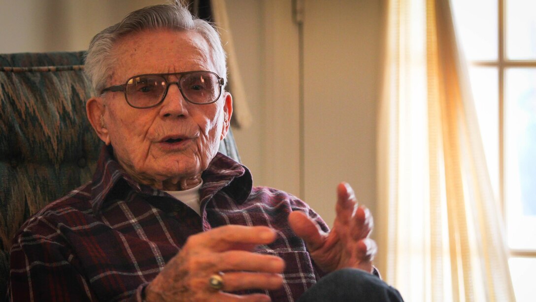 Retired U.S. Marine Staff Sgt. Robert A. Henderson, 95, a Pearl Harbor survivor, tells Clemson University student Will Hines his story for an undergraduate research project called the Veterans Project, Feb. 21, 2015. Hines interviews veterans for the project, and then sends the tapes to the Library of Congress to be preserved forever. "The first plane flew so close to me I could have thrown a rock and hit it," said Henderson. He went on to serve 51 months in combat during WWII, culminating at the Battle of Okinawa. "I was in the first and last battles of the war." (U.S. Army photo by Sgt. Ken Scar)