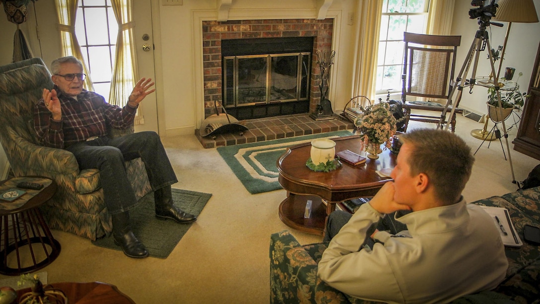 Former U.S. Marine Staff Sgt. Robert A. Henderson, 95, a Pearl Harbor survivor, tells Clemson University student Will Hines his story for the Veterans Project, an unergraduate research project, Feb. 21, 2015. The project was started to assist the Library of Congress collect, preserve and make accessible the personal accounts of American war veterans. "The first plane flew so close to me I could have thrown a rock and hit it," said Henderson. He would go on to serve 51 months in combat during WWII, culminated with the Battle of Okinawa. "I was in the first and last battles of the war," he said. (U.S. Army photo by Sgt. Ken Scar)
