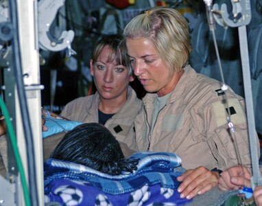 Air Force Master Sgt. Theresa Sheheen (left) and Air Force Capt. Michelle Mulberry tend to a litter patient on an aeromedical evacuation mission June 22, 2007, from Bagram Air Base, Afghanistan. Sheheen is a 455th Expeditionary Aeromedical Evacuation Flight medical technician and Captain Mulberry is a 455th EAEF flight nurse. They both were deployed from the Wyoming Air National Guard's 187th Aeromedical Evacuation Squadron from Cheyenne, Wyo.