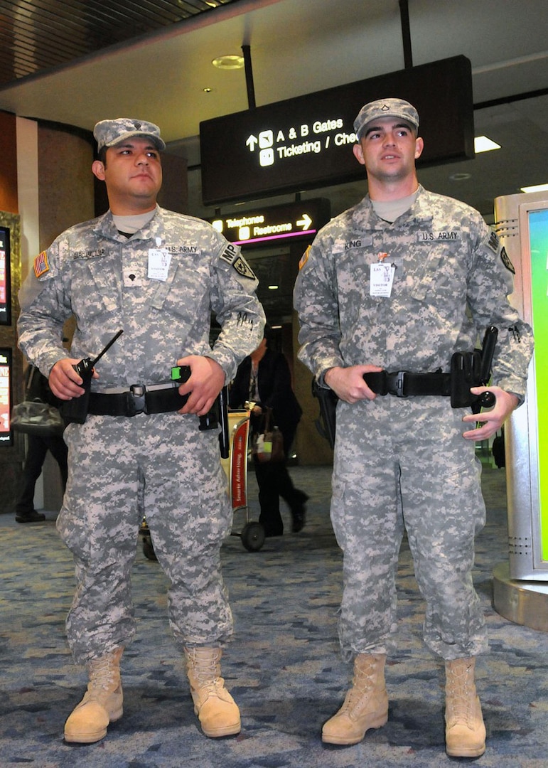 Army Spc. Jesus Garcia Salazar and Army Pfc. Josh King, both with the 72nd 
Military Police Company, stand guard at McCarran International Airport for the 
ninth annual Vigilant Sentinel exercise here, Dec. 31, 2010. Nevada National 
Guardmembers supported Las Vegas Metro Police by providing extra security for 
the holiday.