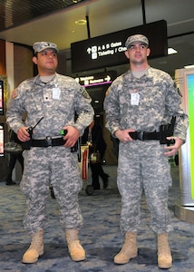 Army Spc. Jesus Garcia Salazar and Army Pfc. Josh King, both with the 72nd 
Military Police Company, stand guard at McCarran International Airport for the 
ninth annual Vigilant Sentinel exercise here, Dec. 31, 2010. Nevada National 
Guardmembers supported Las Vegas Metro Police by providing extra security for 
the holiday.