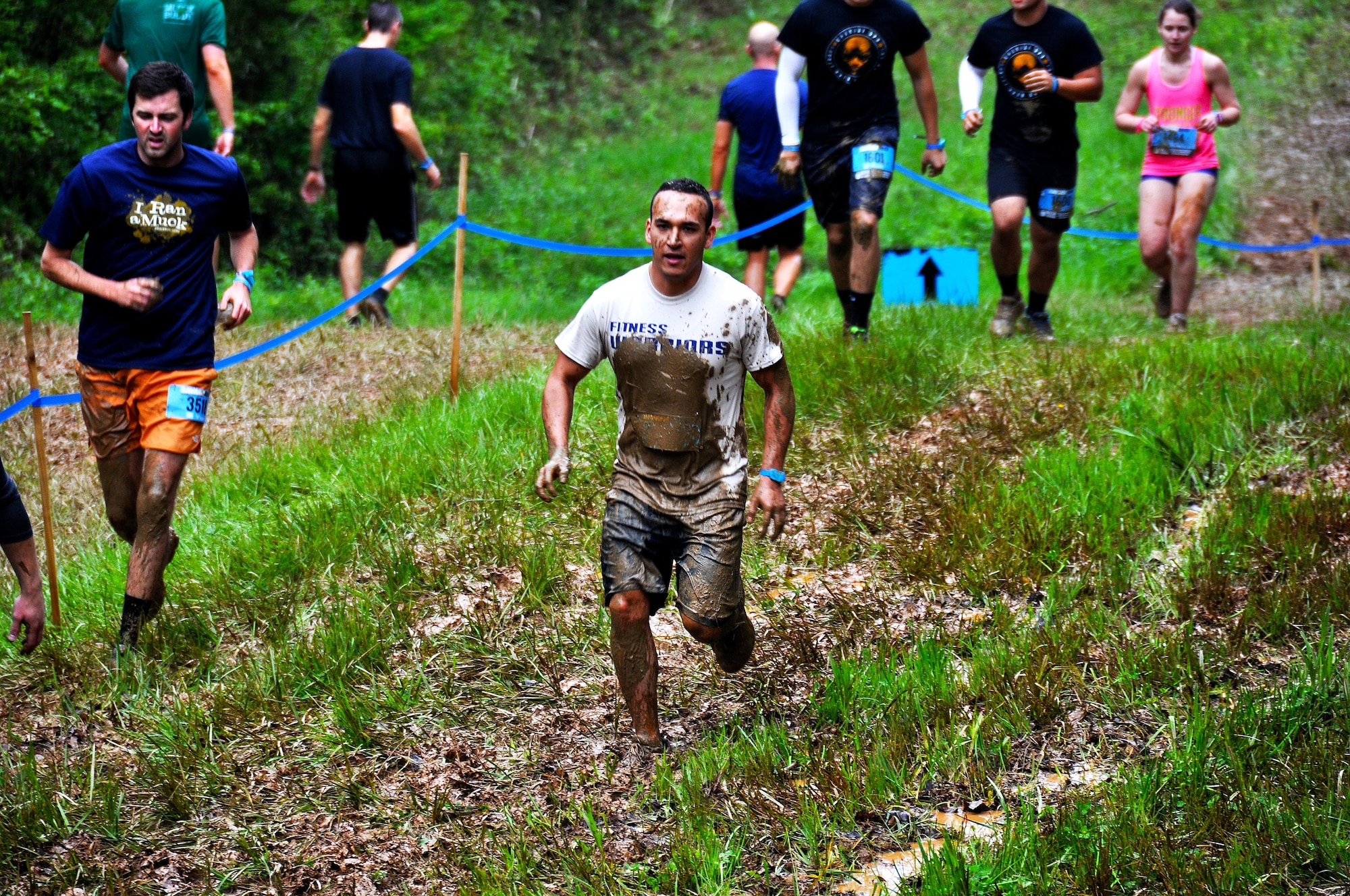 Tech. Sgt. Randy Estrella, 94th Logistics Readiness Squadron vehicle maintainer, races down a muddy hill during the Georgia Spring 2015 Savage Race in Dallas, Ga., April 18, 2015. The Savage Race is an Air Force Reserve sponsored obstacle course that challenges participants in more than 20 different trials over the course of five miles. (U.S. Air Force photo/Senior Airman Daniel Phelps)