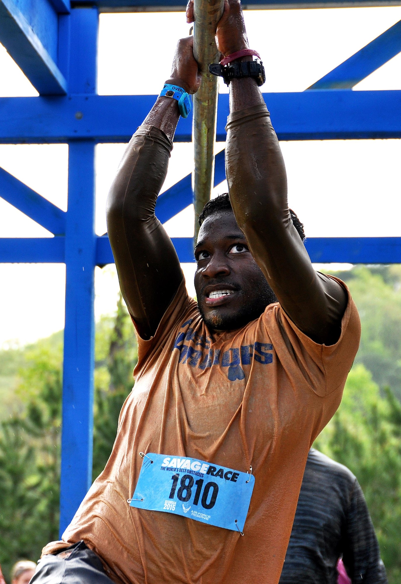 Jordan Jones, son of Senior Master Sgt. Eric Jones, 94th Logistics Readiness Squadron, shimmies across bars over a pool of water during the Georgia Spring 2015 Savage Race in Dallas, Ga., April 18, 2015. The Savage Race is an Air Force Reserve sponsored obstacle course that challenges participants in more than 20 different trials over the course of five miles. (U.S. Air Force photo/Senior Airman Daniel Phelps)
