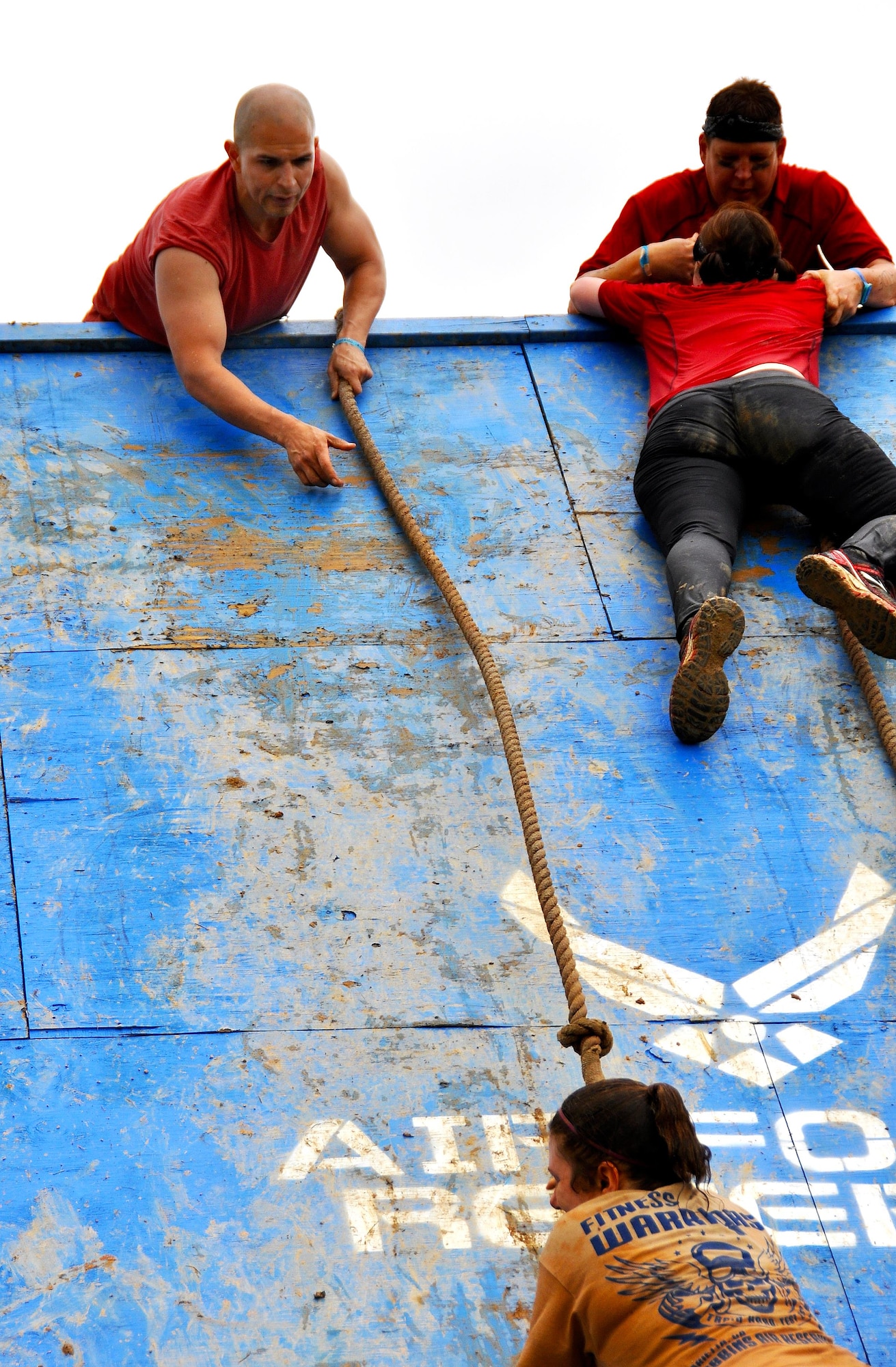 Staff Sgt. Luis Pluguez, 94th Aeromedical Staging Squadron, assists 1st Lt. Banner Zimmerman, 94th ASTS nurse, in climbing a wall during the Georgia Spring 2015 Savage Race in Dallas, Ga., April 18, 2015. The Savage Race is an Air Force Reserve sponsored obstacle course that challenges participants in more than 20 different trials over the course of five miles. (U.S. Air Force photo/Senior Airman Daniel Phelps)