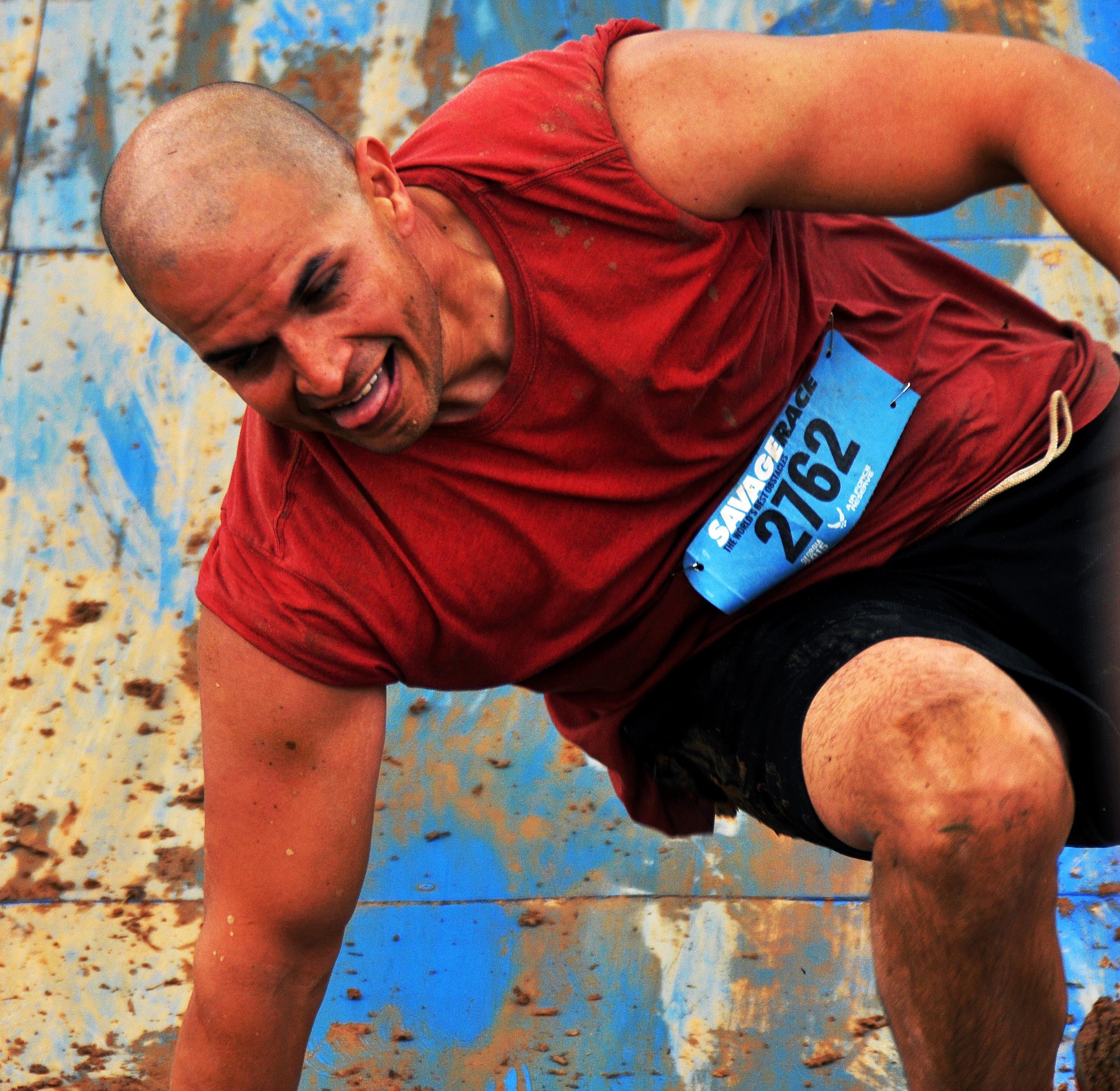 Staff Sgt. Luis Pluguez, 94th Aeromedical Staging Squadron, slides down a wall after a failed attempt at climbing the Colossus during the Georgia Spring 2015 Savage Race in Dallas, Ga., April 18, 2015. The Colossus was a giant 43-foot wall and one of the hardest obstacles in the course. Adding to the difficulty of it being one of the final obstacles, runners had to sprint up the barrier after they’d already sledged through more than four miles in the mud, before grabbing a rope. They would then pull themselves up to the top of the fortification. The Savage Race is an Air Force Reserve sponsored obstacle course that challenges participants in more than 20 different trials over the course of five miles. (U.S. Air Force photo/Senior Airman Daniel Phelps)