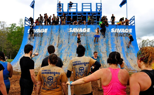 Savage Race participants wait in line to climb the Colossus during the Georgia Spring 2015 Savage Race in Dallas, Ga., April 18, 2015. The Colossus was a giant 43-foot wall and one of the hardest obstacles in the course. Adding to the difficulty of it being one of the final obstacles, runners had to sprint up the barrier after they’d already sledged through more than four miles in the mud, before grabbing a rope. They would then pull themselves up to the top of the fortification. The Savage Race is an Air Force Reserve sponsored obstacle course that challenges participants in more than 20 different trials over the course of five miles. (U.S. Air Force photo/Senior Airman Daniel Phelps)