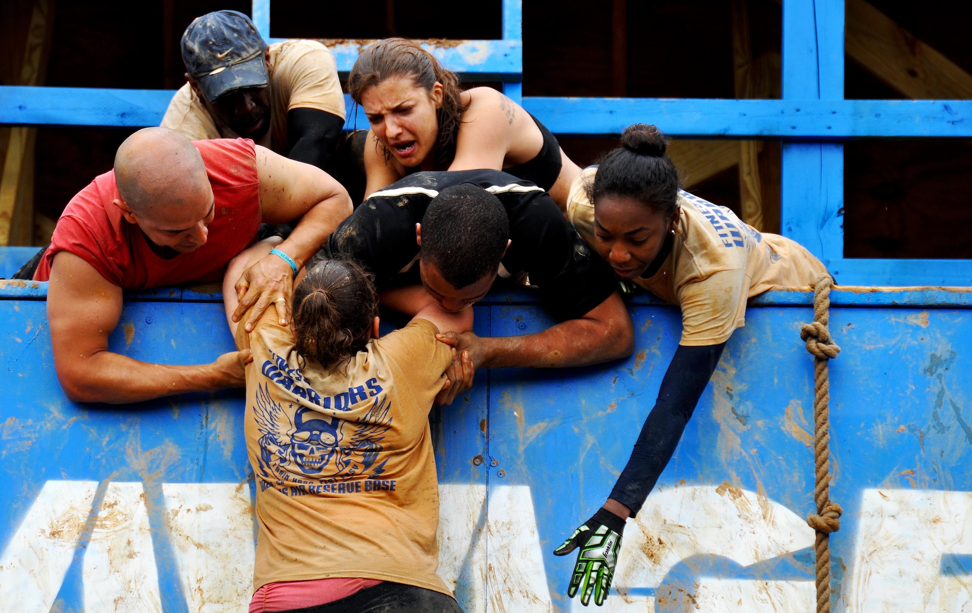 Members of Dobbins Air Reserve Base help 1st Lt. Banner Zimmerman, 94th Aeromedical Staging Squadron nurse, make it to the top of the Colossus during the Georgia Spring 2015 Savage Race in Dallas, Ga., April 18, 2015. The Colossus was a giant 43-foot wall and one of the hardest obstacles in the course. Adding to the difficulty of it being one of the final obstacles, runners had to sprint up the barrier after they’d already sledged through more than four miles in the mud, before grabbing a rope. They would then pull themselves up to the top of the fortification. The Savage Race is an Air Force Reserve sponsored obstacle course that challenges participants in more than 20 different trials over the course of five miles. (U.S. Air Force photo/Senior Airman Daniel Phelps)