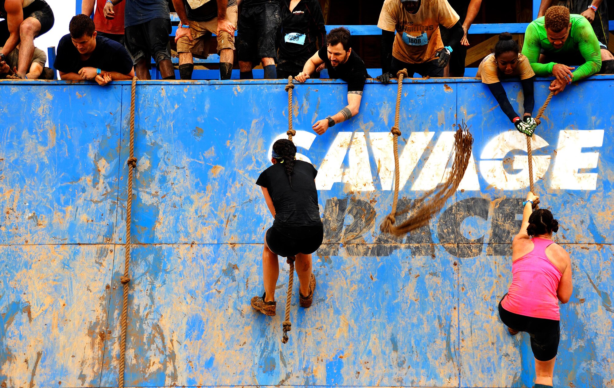 Savage Race participants help other racers make it to the top of the Colossus during the Georgia Spring 2015 Savage Race in Dallas, Ga., April 18, 2015. The Colossus was a giant 43-foot wall and one of the hardest obstacles in the course. Adding to the difficulty of it being one of the final obstacles, runners had to sprint up the barrier after they’d already sledged through more than four miles in the mud, before grabbing a rope. They would then pull themselves up to the top of the fortification. The Savage Race is an Air Force Reserve sponsored obstacle course that challenges participants in more than 20 different trials over the course of five miles. (U.S. Air Force photo/Senior Airman Daniel Phelps)