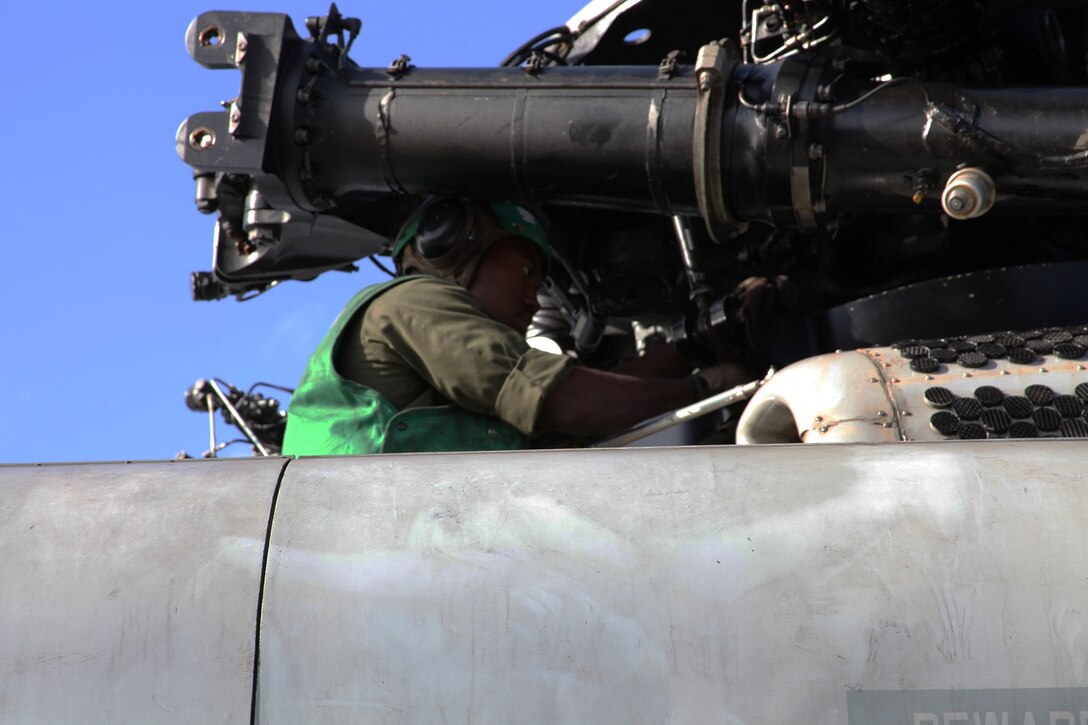U.S. Marine Lance Cpl. Selim Griggsross provides maintenance on a CH-53E Super Stallion aboard USS Essex (LHD 2) at sea in the Pacific Ocean, May 17, 2015. Griggsross is an airframe mechanic with Marine Medium Tiltrotor Squadron 161 (Reinforced), 15th Marine Expeditionary Unit. The aviation combat element of the 15th MEU maintains a state of combat readiness through constant upkeep on aircraft while on deployment. (U.S. Marine Corps photo by Staff Sgt. Miguel Carrasco/Released)