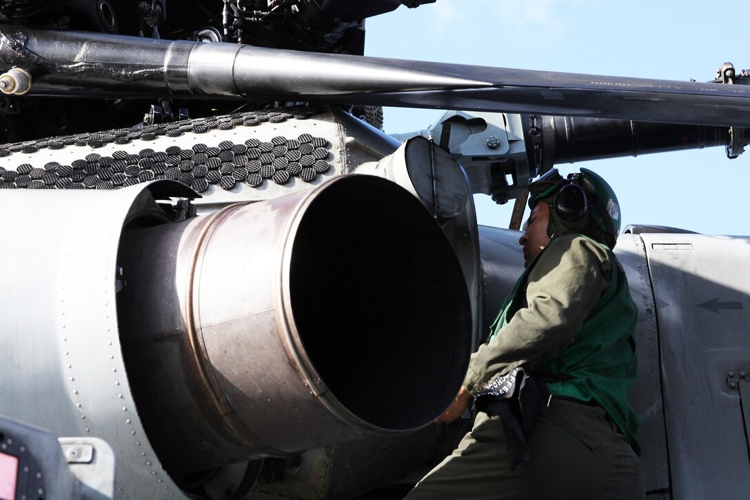 U.S. Marine Lance Cpl. Jaime Torrez provides maintenance on a CH-53E Super Stallion aboard USS Essex (LHD 2) at sea in the Pacific Ocean, May 17, 2015. Torrez is an airframe mechanic with Marine Medium Tiltrotor Squadron 161 (Reinforced), 15th Marine Expeditionary Unit. The aviation combat element of the 15th MEU maintains a state of combat readiness through constant upkeep on aircraft while on deployment. (U.S. Marine Corps photo by Staff Sgt. Miguel Carrasco/Released)