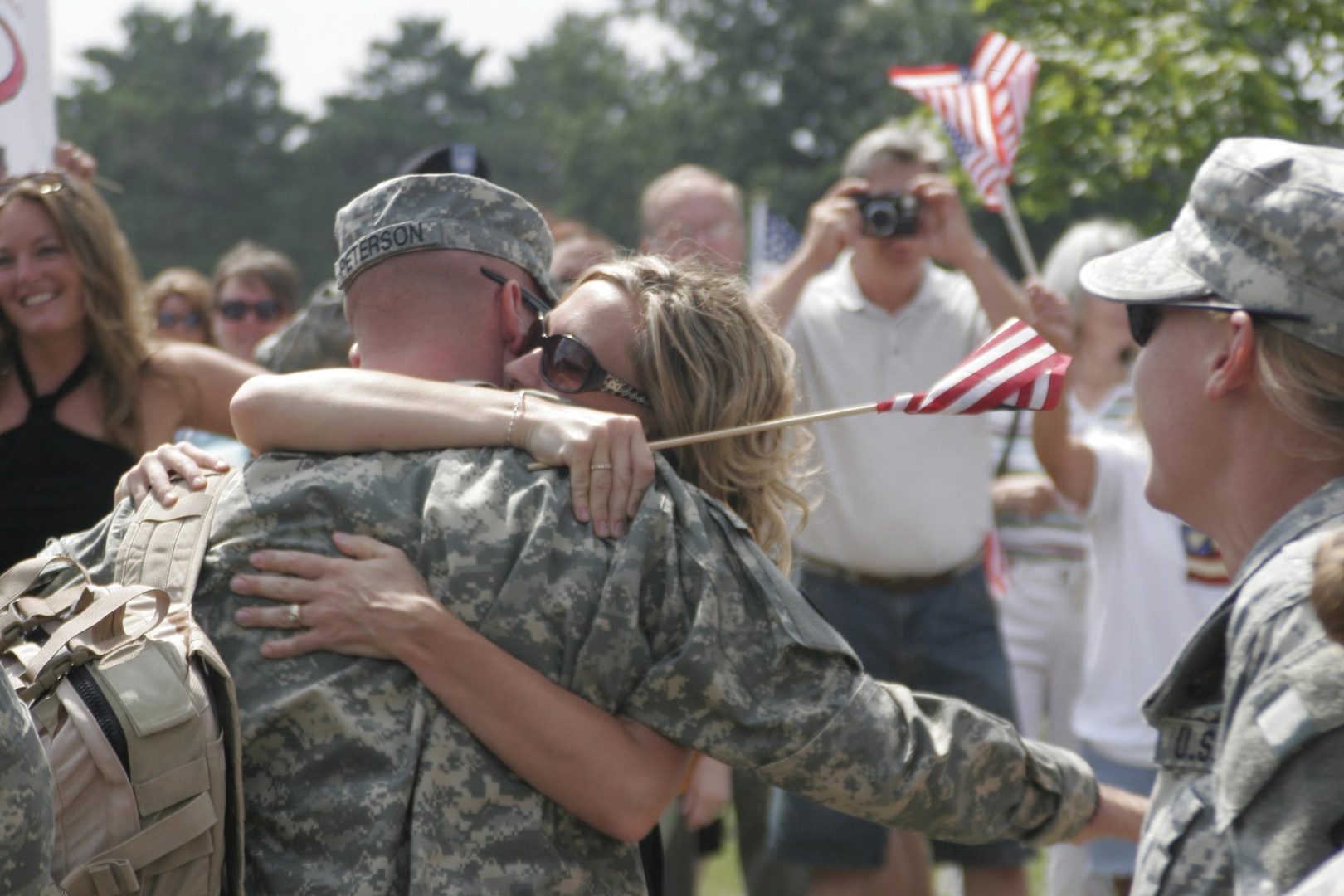 Army Sgt. Mike Peterson receives hugs and kisses from his wife for the first time since coming home from Iraq at Brooklyn Park Armory in Minnesota on July 17, 2007. Peterson is a Soldier with Alpha Company, 134th Brigade Support Battalion, who was in Iraq with the 1st Brigade Combat Team, 34th Infantry Division. 34th ID Guardmembers participated in a study that suggested some post-deployment challenges arise from post-traumatic stress rather than traumatic brain injury